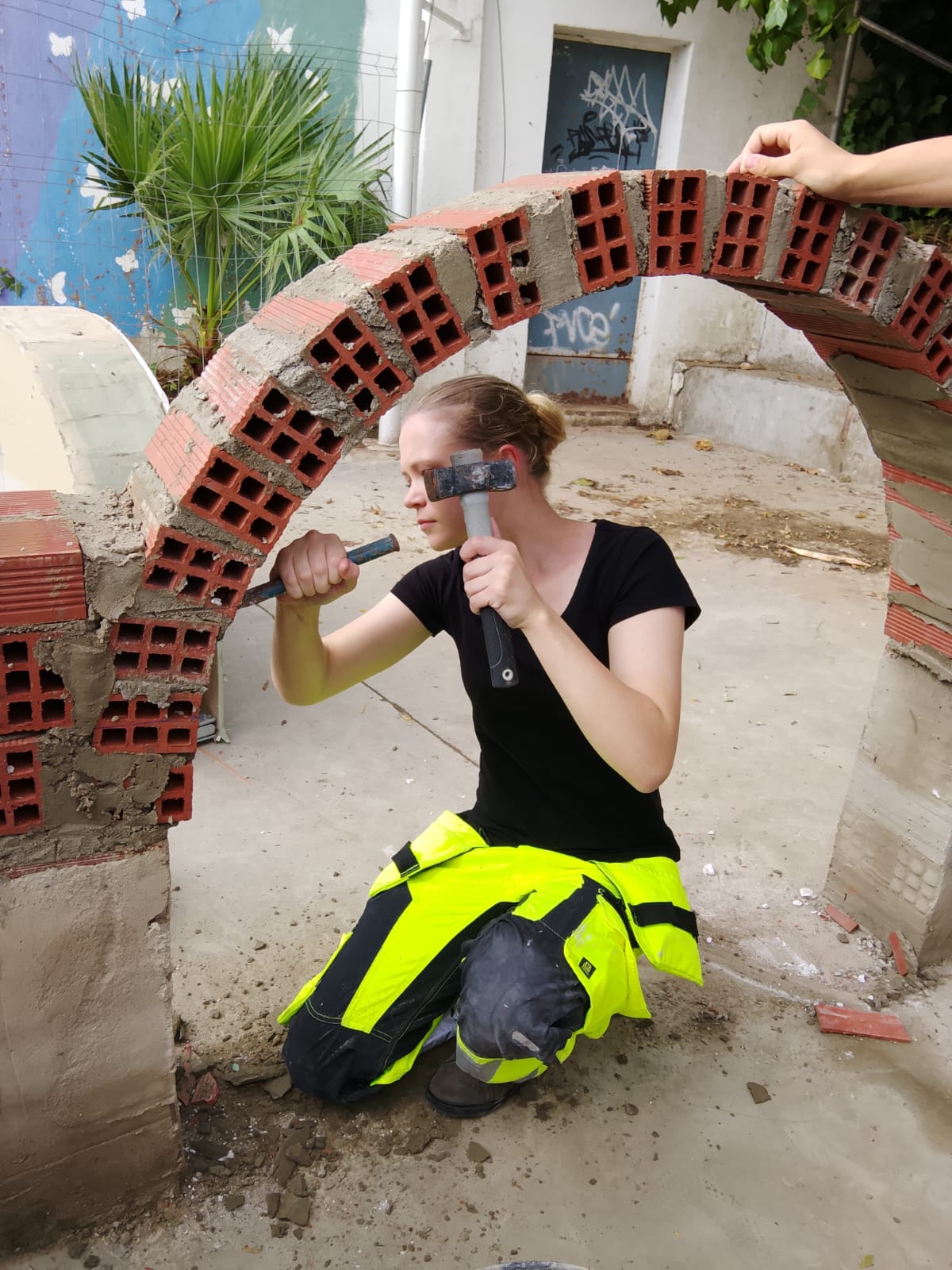 Swedish carpentry student chiselling bricks on an arch during a school Swedish carpentry student chiselling bricks on an arch during a school mobility in Córdoba